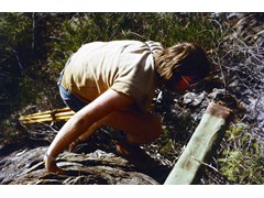 1974 : Traversing in western Queensland; Bruce Hewitt climbing to trig with survey equipment.