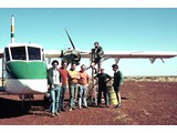 1977 : Nomad N22B-25 VH-DNM refueling at Kidson Field (L-R) Leon Derkacz, Laurie McLean, Tony Maginn, Paul Wise, Oz Ertok, Pat O'Donohue (contract pilot) and Graeme Lawrence on ladder.